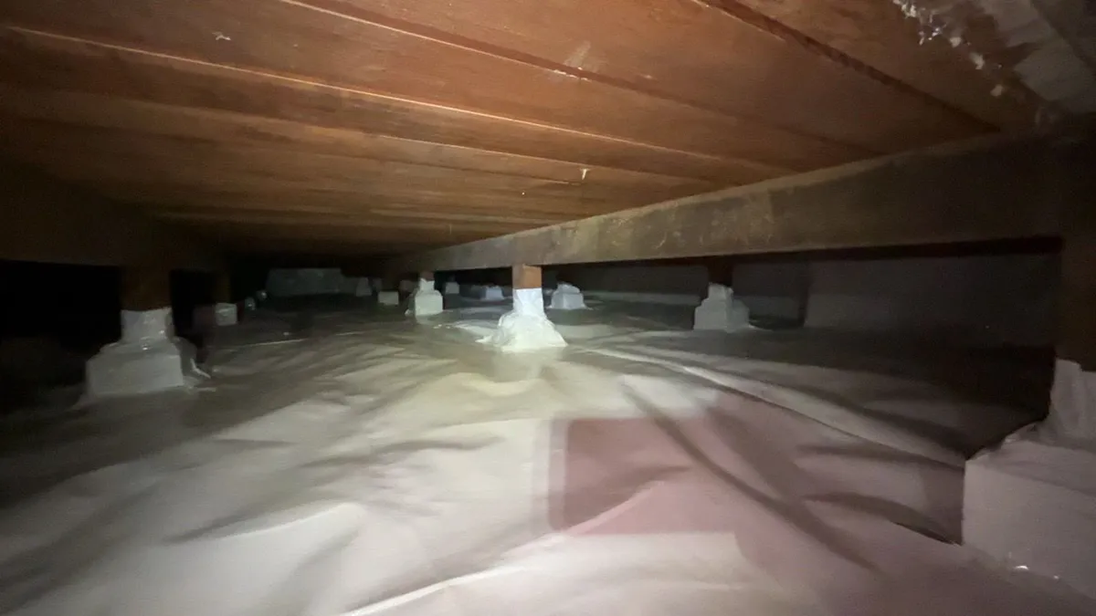 Liner across the dirt floor, piers wrapped