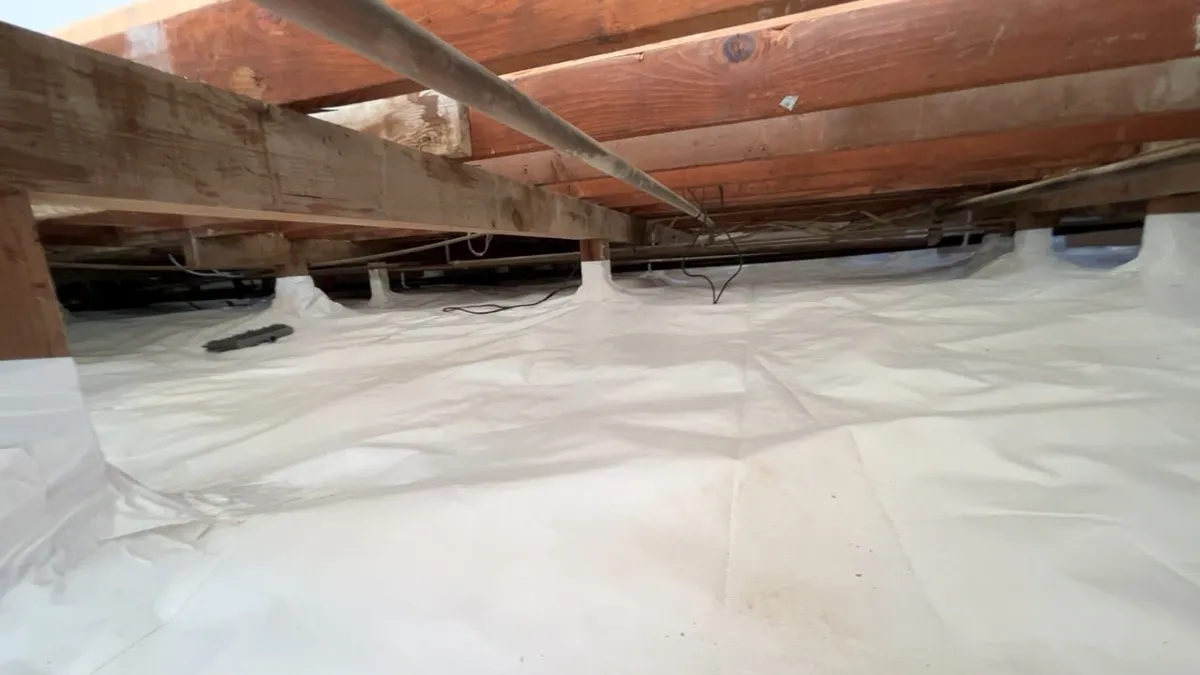 A full crawlspace sealed, seams overlapped